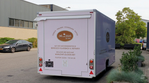 Achteraanzicht van een aanhangwagen voor gebak, chocolade en koffie