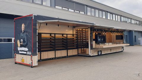 Zijaanzicht van een uitschuifbare aanhangwagen voor brood en banket met geopende luifel