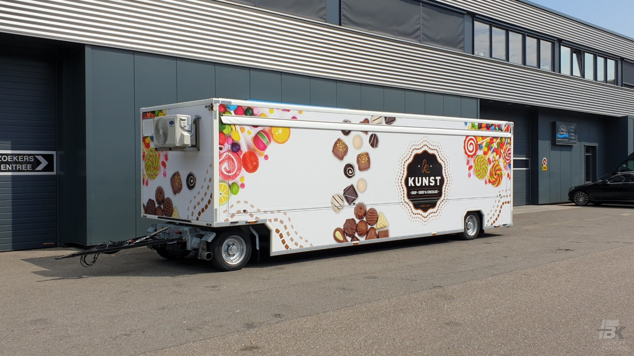 Zijaanzicht van een aanhangwagen voor drop, snoep en chocolade met gesloten luifel