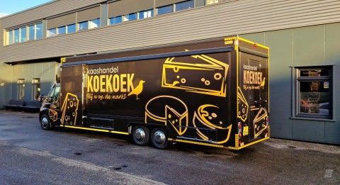 Zijaanzicht van een verkoopwagen voor kaas met gesloten luifel