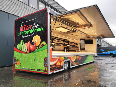 Achteraanzicht van een aanhangwagen voor groente en fruit met geopende luifel