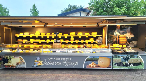 Volledig uitgestalde aanhangwagen voor kaas, op een standplaats