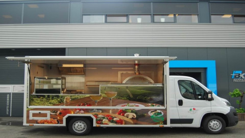 Zijaanzicht van een verkoopwagen voor Italiaanse delicatessen met geopende luifel