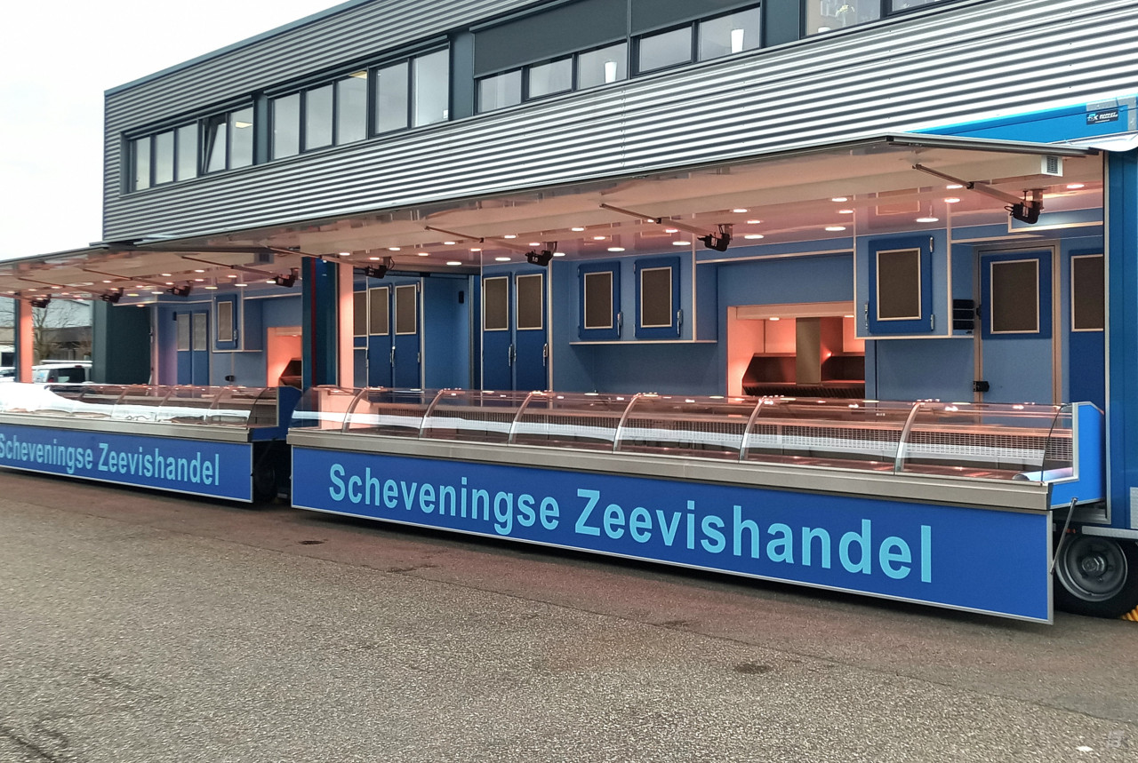 Zijaanzicht van twee verkoopwagens voor vis met geopende luifels