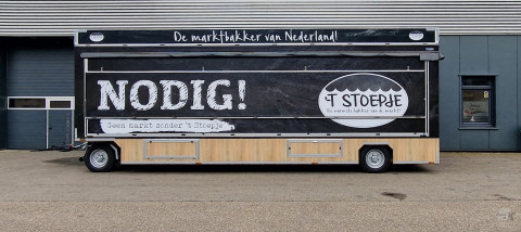 Zijaanzicht van een aanhangwagen voor brood en banket met gesloten luifel