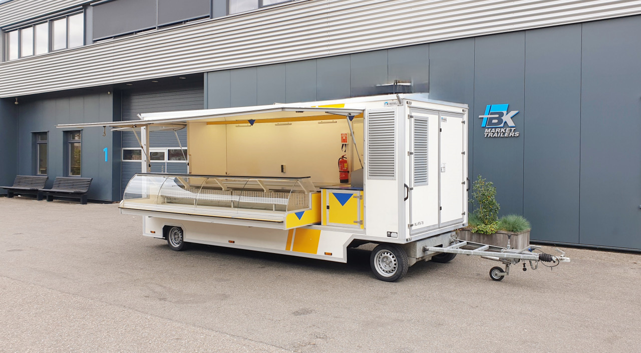 Zijaanzicht van een aanhangwagen voor diverse branches met geopende luifel