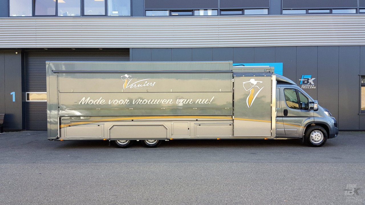 Zijaanzicht van een verkoopwagen voor mode met gesloten luifel