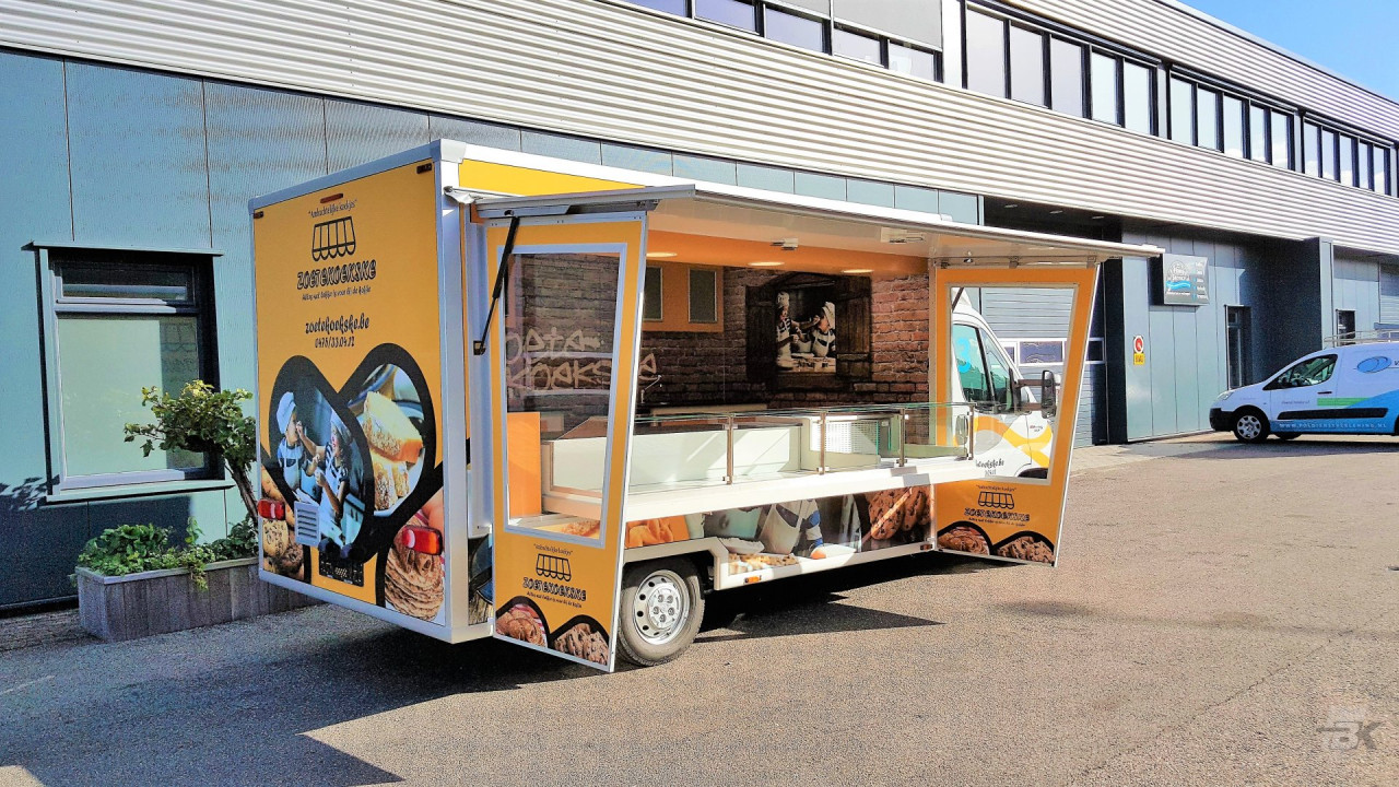 Zijaanzicht van een verkoopwagen voor koeken met geopende luifel