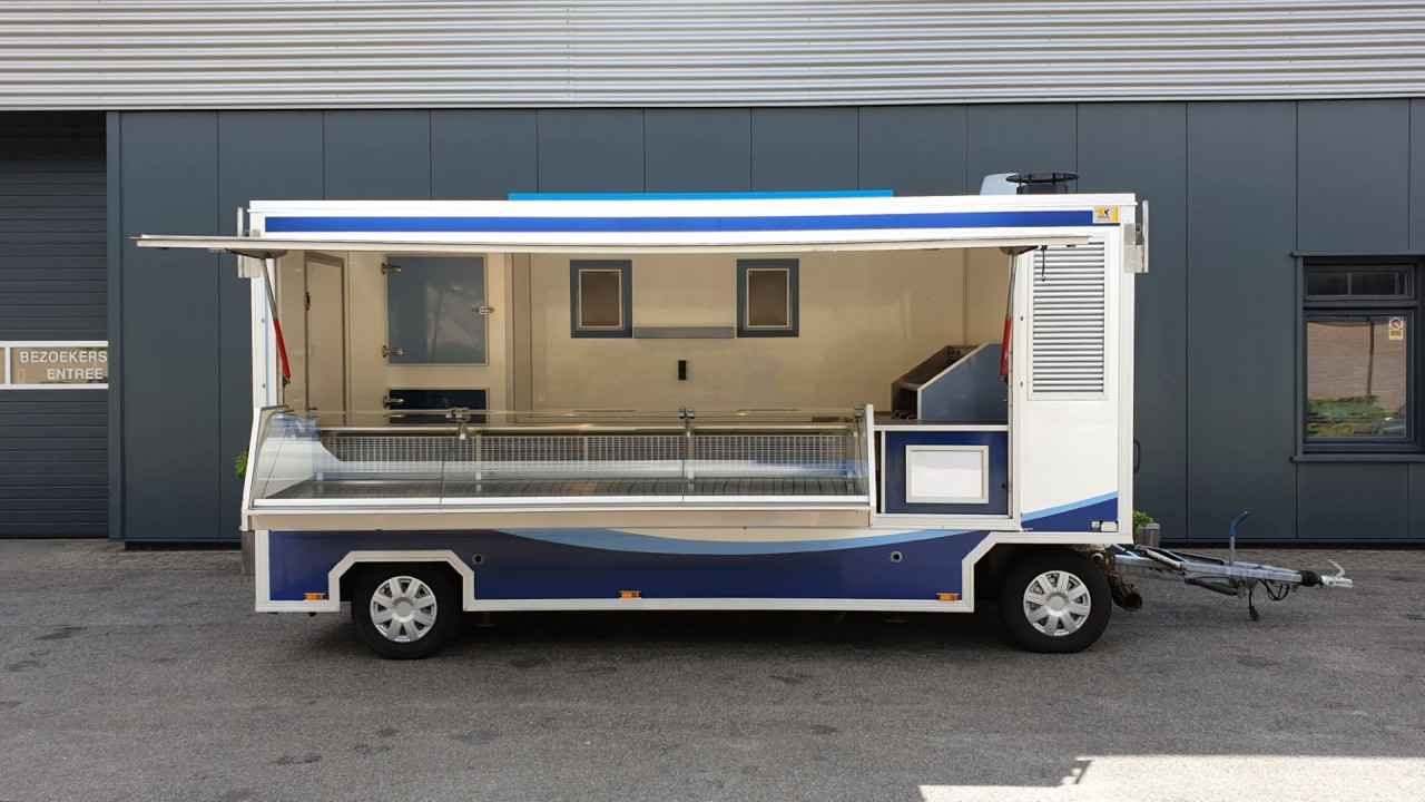 Zijaanzicht van een aanhangwagen voor diverse branches met geopende luifel
