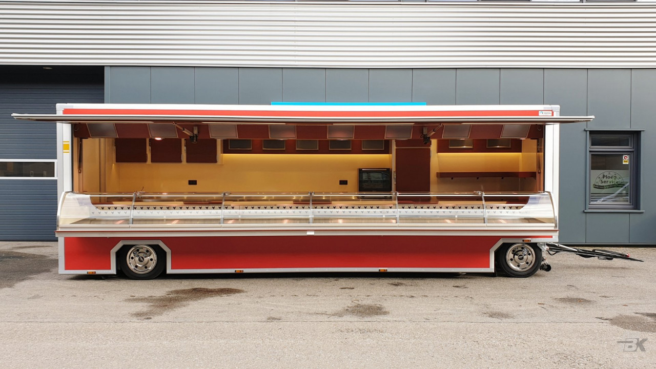 Zijaanzicht van een aanhangwagen voor kip met geopende luifel